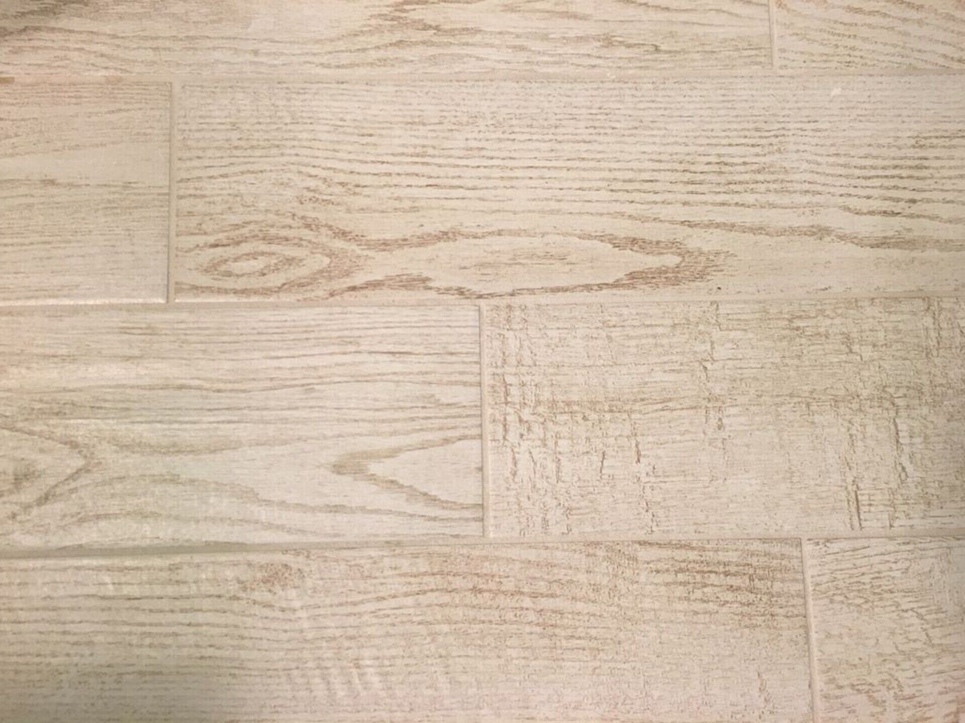 Un primo piano di un pavimento in legno con venature naturali.