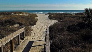 A wooden boardwalk leading to a beach with dunes and sparse vegetation. - Ocean View Villa with Amazing Resort Amenities -- just steps from the beach!!! (Hilton Head Island)