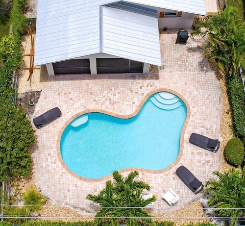 Relax by the sand at nearby Vanderbilt Beach or hang by heated pool