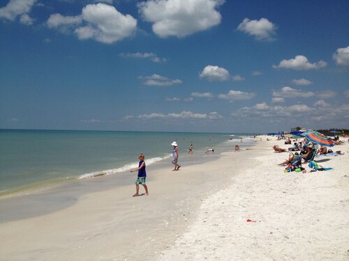 Relax by the sand at nearby Vanderbilt Beach or hang by heated pool