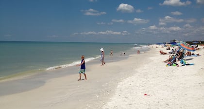 Relax by the sand at nearby Vanderbilt Beach or hang by heated pool