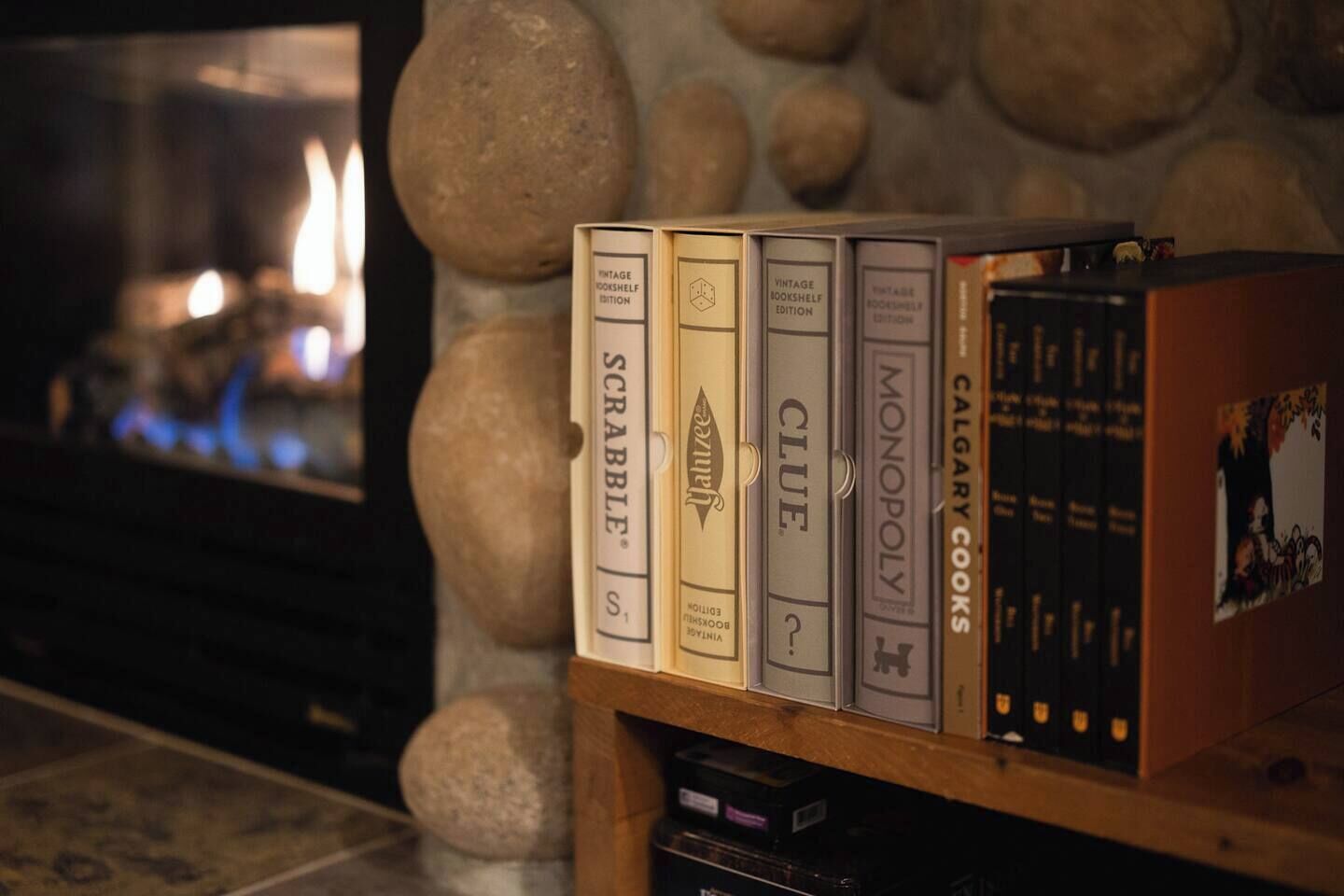 A bookshelf with vintage board games and books.