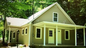 A two-story house with a porch, a garage, and a small front yard.