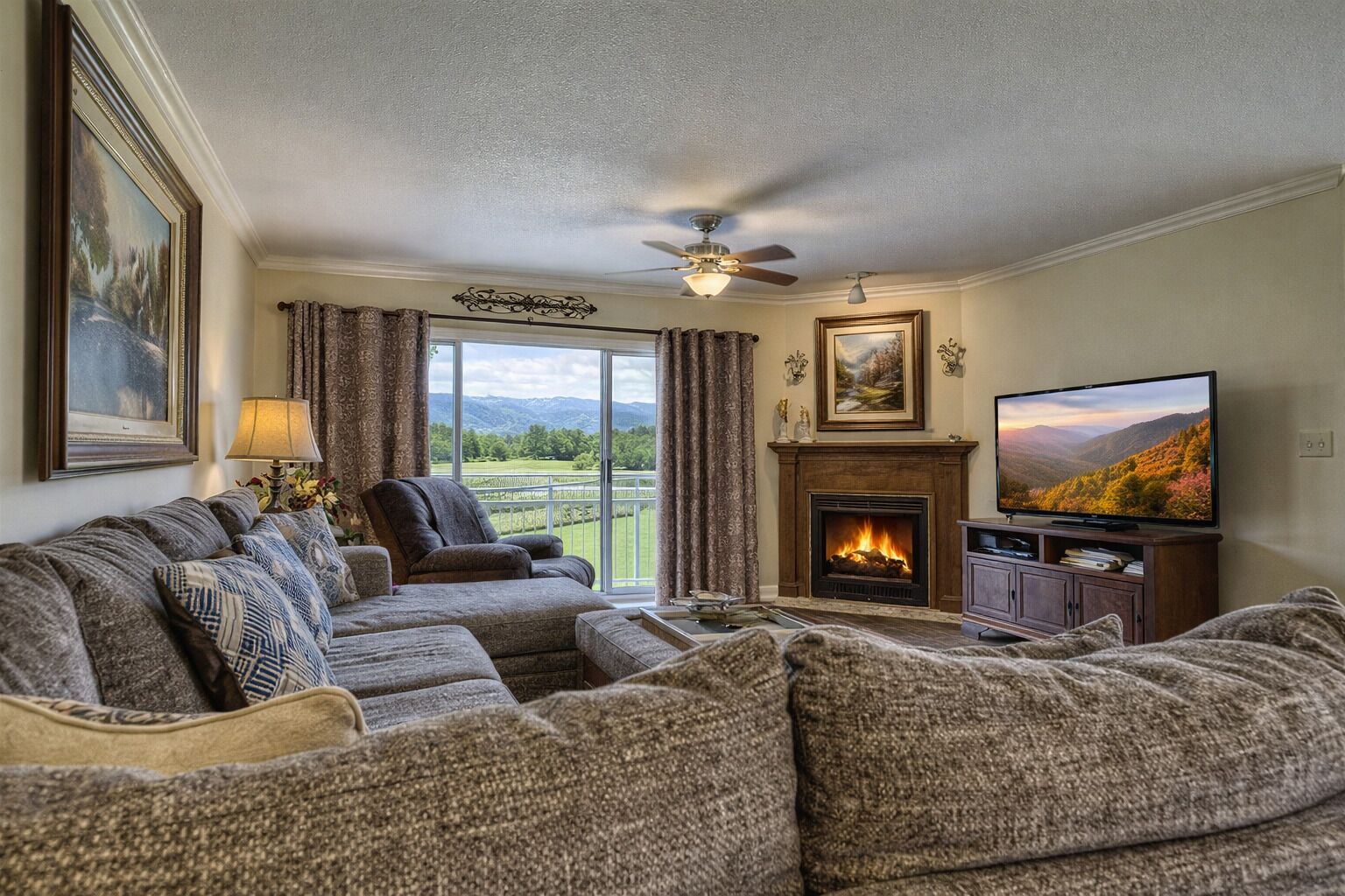 A living room with a fireplace, a television, and a sofa set.
