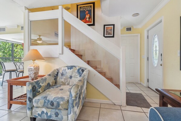 A staircase with a white handrail and a glass door at the top.