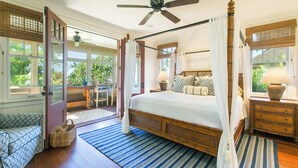 A spacious bedroom with a large bed, a ceiling fan, and a view of the outdoors. - Hale Wai'olu by Alekona Kauai: Luxury 3br ocean view home in Kukuiula, AC, private pool, fire pit (Koloa)
