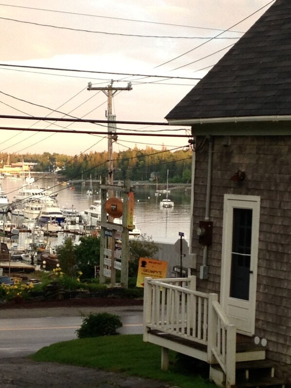 A waterfront property with a dock, boats, and a sign for Grumpy's.