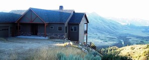 A house with a stone foundation, a sloped roof, and a wooden deck. - Spectacular views and rural life, yet close to Boise (Boise)