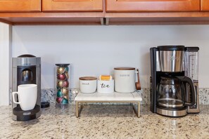 A kitchen counter with a coffee maker, a scale, and containers labeled 'sugar' and 'tea'. - Upscale and Historic, 2 blocks to Streetcar, 4 to French Quarter, 6 to Frenchmen (New Orleans)