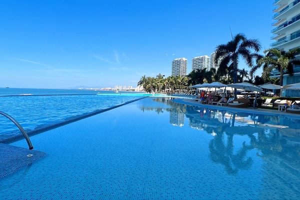 Infinity pool with wading pool for young children.