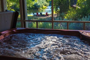 A hot tub with a view of a river and chairs outside. - On the Rio Grande River!!  Rinconada Rio Grande Retreat (Taos)