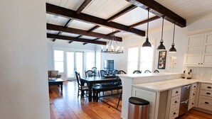 A spacious kitchen with wooden flooring, a central island, and pendant lighting. - *PRIVATE BEACH*    *PRIVATE POOL*    *ELEVATOR*    *6 BEACH BIKES* (Panama City)