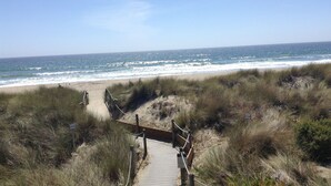 A wooden boardwalk leading to a beach with a clear view of the ocean. - Modern Beach Front Pajaro Dunes 1st Floor Condo - Yards From Beach/Gated Entry (Watsonville)
