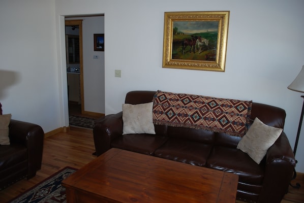 Cozy living room has a sofa & loveseat. Cable TV and a DVD player are provided.