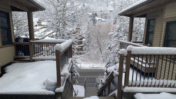 A snowy staircase leading to a porch with snow-covered railings and steps. - Deer Valley Townhouse, with New Private Hot Tub Just Steps Away from the Bus (Park City)
