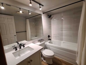 Combined shower/bathtub, hair dryer, towels, soap