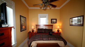 A bedroom with a bed, two bedside tables, a ceiling fan, and a window. - AWESOME STURGIS HOME FOR STURGIS RALLY (Sturgis)