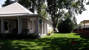 A single-story house with a porch, a flag, and a 'No Trespassing' sign. - AWESOME STURGIS HOME FOR STURGIS RALLY (Sturgis)