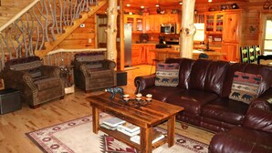A log cabin interior with a living room, kitchen, and staircase. - Double-Decker Dock - Beautiful View (Blairsville)