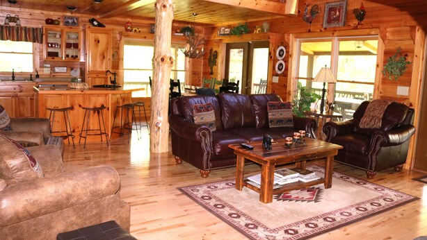A log cabin interior with a living room, kitchen, and dining area. - Double-Decker Dock - Beautiful View (Blairsville)