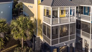 A multi-story house with a balcony, a chimney, and a view of the surrounding area. - The Misty Breeze! Cabana Club, Ocean View, Golf Cart  (Fripp Island)