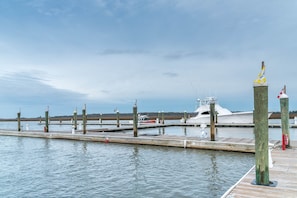 Moored boats line the marina's wooden docks, offering serene views of the calm waters.