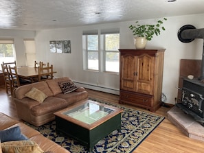 Relax in a warm living space with a leather sofa, coffee table, and area rug.