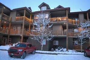 Un hôtel à plusieurs étages, doté de balcons et dont le sol est recouvert de neige.