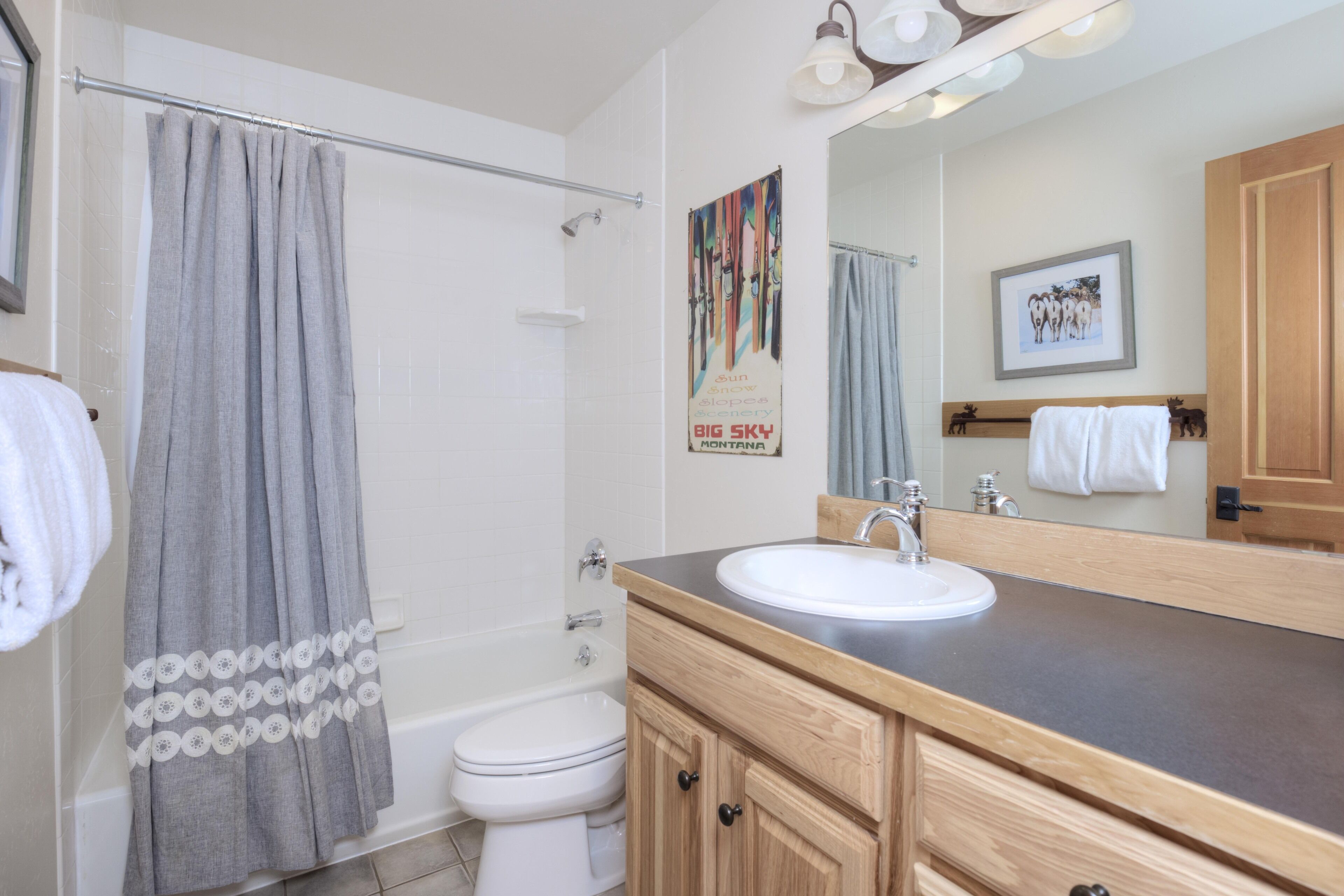 A bathroom with a bathtub, toilet, and sink.