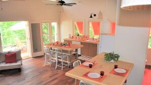 Eine moderne Küche mit Essbereich, Holzboden und Deckenventilator.