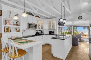 Enjoy meals in the spacious kitchen with a large island, dining area, and cozy seating.
