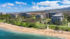 A resort with multiple high-rise buildings, a beachfront, and a pool area. - Oceanfront Views Above Dukes - Wrap Around Lanai - Outdoor Kitchen 🌺 Honua Kai H351 (Lahaina)