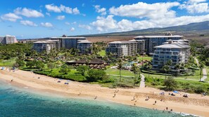 A resort with beachfront properties, a pool, and lush landscaping. - Oceanfront Views Above Dukes - Wrap Around Lanai - Outdoor Kitchen 🌺 Honua Kai H351 (Lahaina)