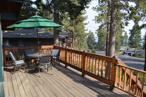 Relax on the deck with a view of the surrounding area, enjoying the shade from the umbrella.