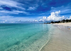 Enjoy a serene beachside retreat with turquoise waters and a sandy shoreline.