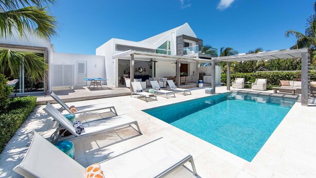 A modern pool area with lounge chairs and a clear blue pool. - Second Chances: Spacious Villa w/Pool, Near Beach (Leeward Settlement)