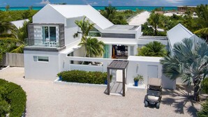 A modern beach house with a large balcony, a covered patio, and a view of the ocean. - Second Chances: Spacious Villa w/Pool, Near Beach (Leeward Settlement)