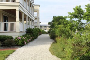Stroll through lush gardens to the entrance of this traditional building with a symmetrical facade and evenly spaced windows.