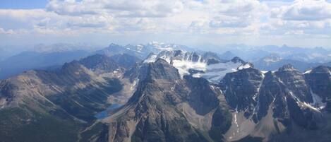 A mountainous landscape with a prominent lake and snow-capped peaks.