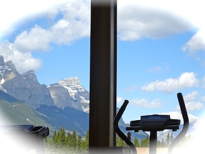 Enjoy breathtaking mountain views from the comfort of your room, where a stationary exercise bike invites you to stay active.