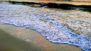 A beach with waves and a sunset. - Beautiful Sunsets On White Sandy Beach , Great Heated Pool - (Marco Island)