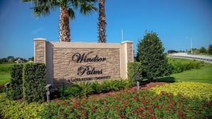 A sign for Windsor Palms, part of the Green Resort Community, with a landscaped garden and palm trees. - Private Pool/Spa, Outdoor TV, Woodland Views, Windsor Palms, Minutes to Disney (Kissimmee)