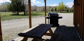 A wooden picnic table and a barbecue grill in an outdoor setting with a gravel ground, surrounded by trees and a mountain in the background. - MT Yellowstone River Retreat, by Chico Hot Springs
Cabin 1 bedroom 1 bathroom
(Livingston)