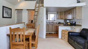 A compact living space with a dining area, kitchen, and a sofa. - ABSOLUTE SKI-IN/OUT IN TOWN! GREAT VIEWS! HOT TUB! PRIVATE GARAGE! 2 BED + LOFT! (Telluride)