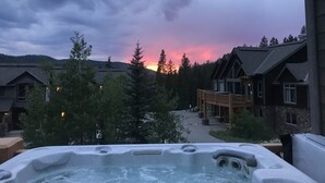 A hot tub with a view of a resort area, including buildings and trees. - 2 Masters, Private Hot Tub, Superb Views - Close to WP Resort Skiing, Biking (Winter Park)