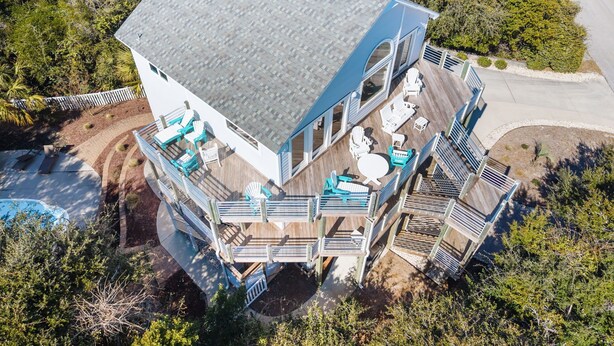 A multi-level house with a deck, outdoor seating, and a swimming pool. - 3rd Row Oceanview,Private pool,hot tub,pet friendly,very short walk to beach (Emerald Isle)