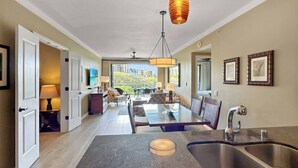 A modern kitchen with a central island, double sinks, and a pendant light. - ❤️Luxury 2 BD Condo at Honua Kai Resort on the Beach ❤️ (Kaanapali)