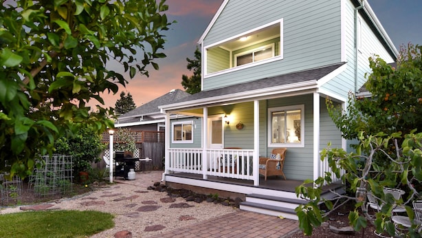 A two-story house with a covered porch, a fenced backyard, and a gravel pathway leading to the entrance. - Walk to Downtown from this Spacious Home (Napa)