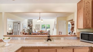 A kitchen with granite countertops, wooden cabinets, and a built-in microwave. - Walk to Downtown from this Spacious Home (Napa)
