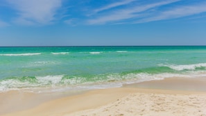 A beach with clear turquoise water and a sandy shore. - Golf cart, newly renovated villa, pet friendly! (Destin)